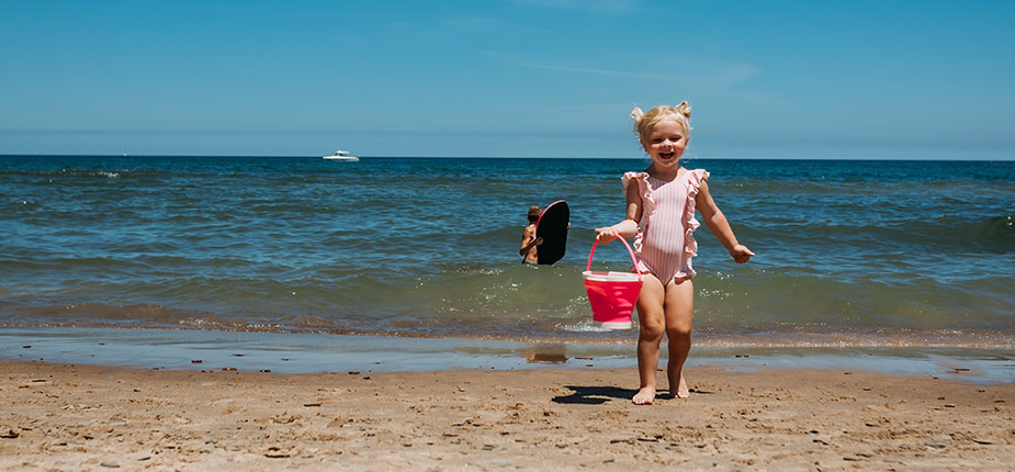 Little girls playing on lake Michigan beach